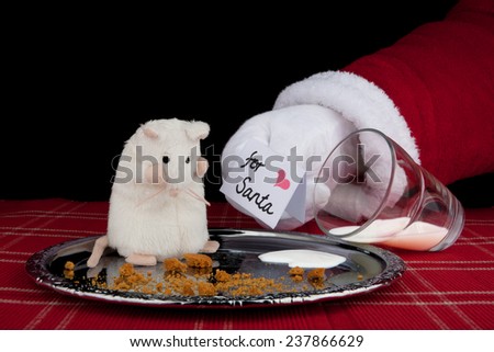 Christmas background. Santa Claus shows a greeting card to a mouse, that has eaten Santa\'s cookies and drunk milk.