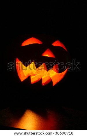 Creepy carved pumpkin face in dark