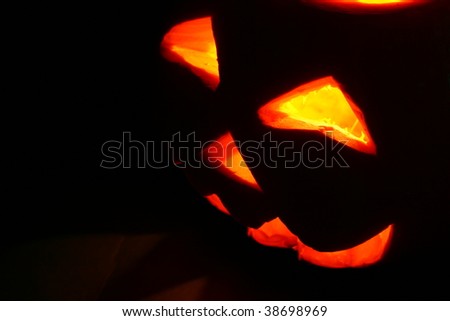 Creepy carved pumpkin face in dark