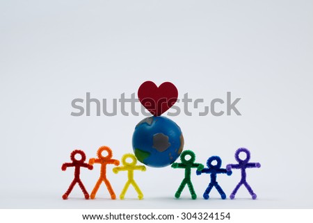 A rainbow of pipe cleaner people holding the world with a heart. Working in unity to love and save the world. This photo could be used for multicultural, international, educational, or other ideas.