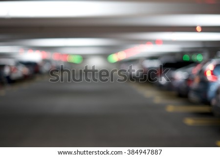 BLUR IMAGE OF INDOOR PARKING SPACE WITH CAR PARKING SPACE LED INDICATOR