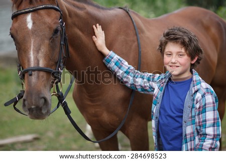 little boy clean his horse