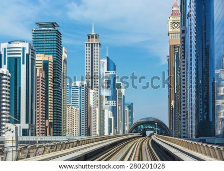 DUBAI,UNITED ARAB EMIRATES-DECEMBER 5, 2013: Skycrapers in modern centre of Dubai with metro railways,Dubai,United Arab Emirates