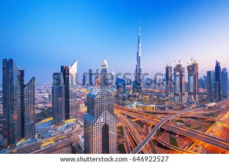 Dubai skyline at sunset with beautiful city center lights and Sheikh Zayed road traffic, Dubai, United Arab Emirates