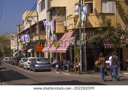 TEL AVIV ,ISRAEL- APRIL 15, 2013: Unidentified people on a Shabazi street in Tel Aviv, decorated with Israeli flags for Israel\'s Independence Day (Yom Haatzmaut), On April 15, 2013 in Tel Aviv,Israel.