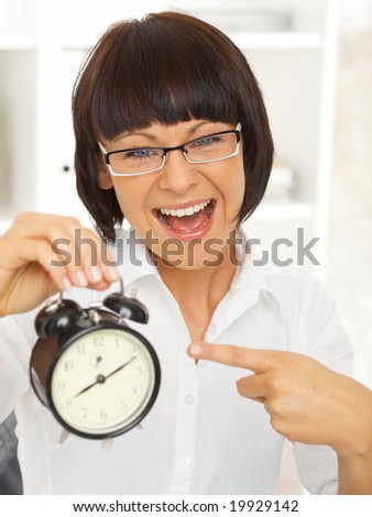 Beautiful business woman with clock in office