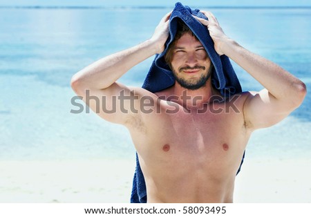 Portrait of a handsome young man with a towel on his head
