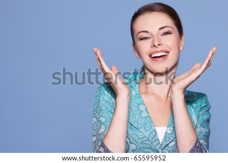 Portrait of beautiful smiling woman isolated on blue with copyspace