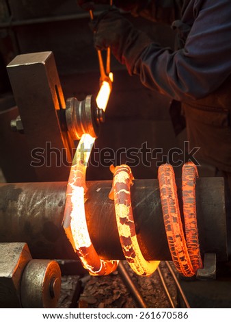 red hot bars being coiled into springs,Sheffield,Britain. taken 15/02/2014