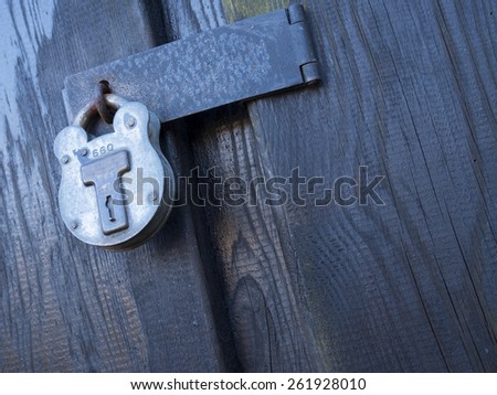 padlock on a wooden warehouse door