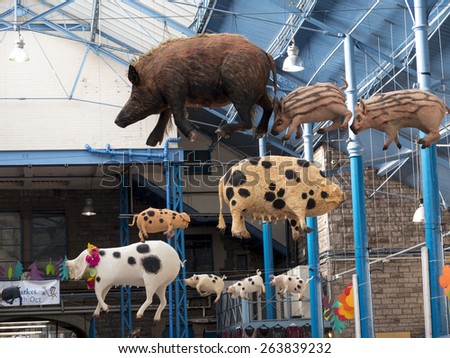 pigs suspended from the ceiling,indoor market hall,Abergavenny,Wales.UK. taken 17/10/2014