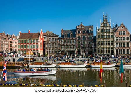 Gent - March 15: Unidentified tourists visit historical center of Gent with gabled houses along river Leie in Gent, March 15, 2015 in Gent, Belgium
