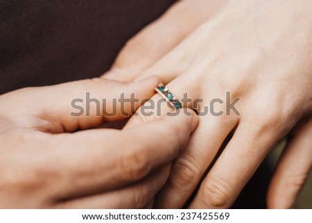 Fiancee puts a ring on finger of his girlfriend. Wedding proposal