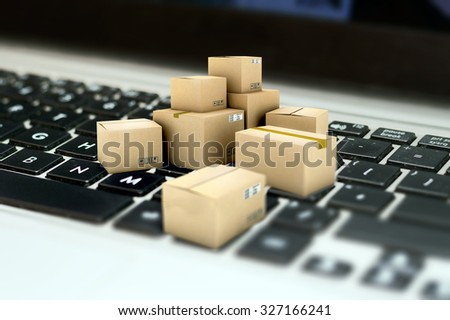 Internet shopping, merchandise cardboard boxes on laptop keyboard