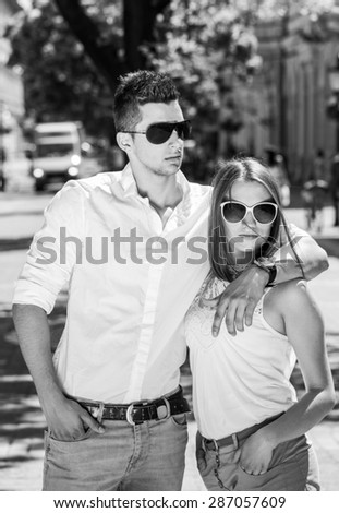 young couple in sunglasses in summer, city outdoor, black and white photography