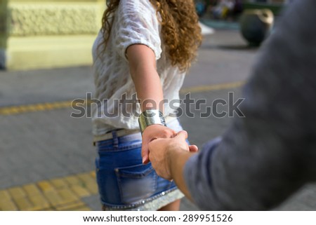 young couple pulling hand