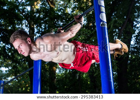 Man practice street workout in a park