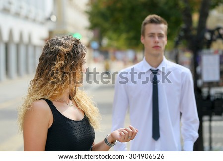 brunette woman is turning back to the businessman on the street