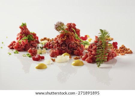 Beef tartar with mustard and beetroot on a white background