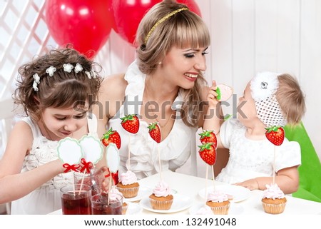 Portrait of a mother and daughter at the table for his birthday