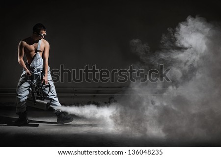 Young man with a smoke machine
