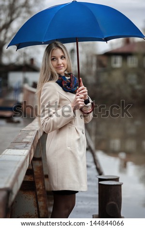 Young girl on a bridge on a cloudy rainy day