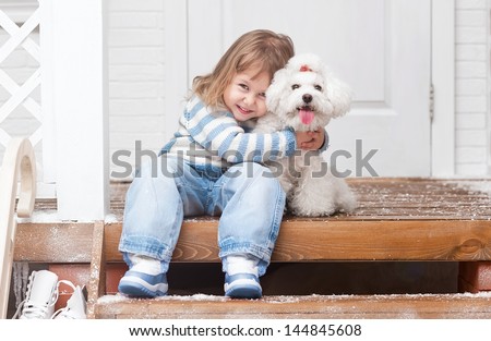 Girl with a dog on the front porch