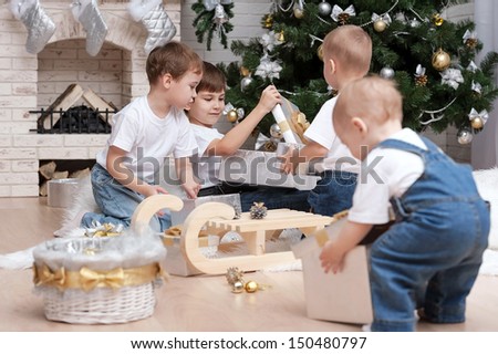 Children make out gifts at Christmas tree