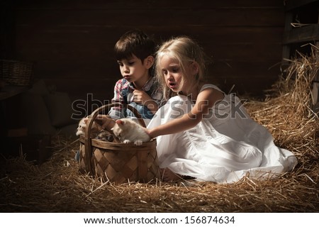 Young children are thrown in the basket of kittens in the barn
