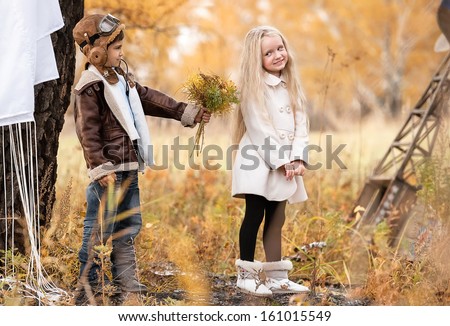 Meeting the young aviator with the girl in the field autumn clear day