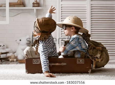 Two boys in the form of an aircraft pilot and traveler playing in her room