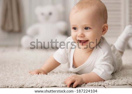 Portrait of a crawling baby on the carpet in my room