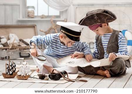 Two boys, a pirate captain, read travel map in her room