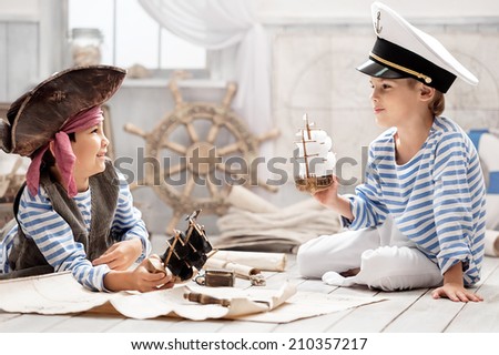 Two boys, a pirate and a sailor, played in a naval battle in his room