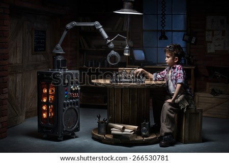 Boy mechanic robot helper playing chess in the studio in the evening