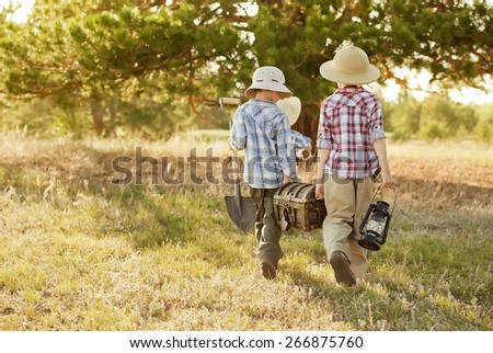 Three boys found a treasure under a tree sunny summer day