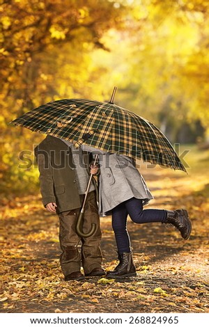 Boy and girl walk in autumn park on a warm sunny day