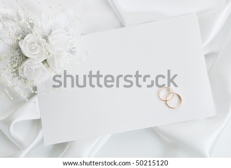 stock photo The wedding invitation with wedding rings and a bouquet of the 