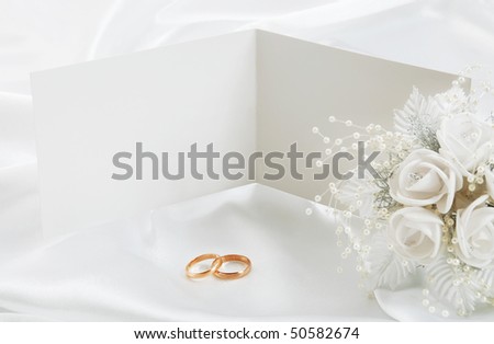 stock photo The wedding invitation with wedding rings and a bouquet of the