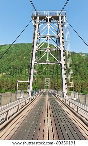 The iron bridge through the river in mountains