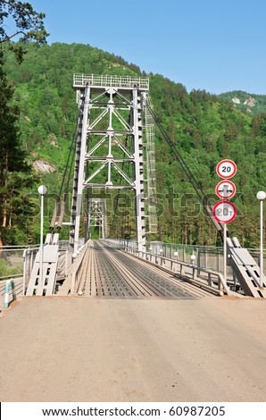 The iron bridge through the river in mountains