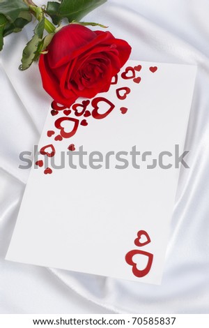 Red rose with the invitation to a white background