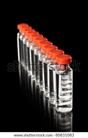 Medical bottles in the row isolated on black