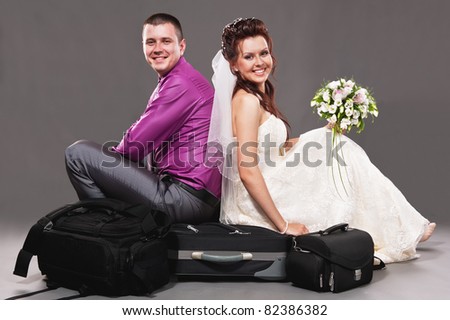 Portrait of the bride and the groom in studio on a grey background
