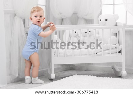Smiling baby with toys on the carpet in my room