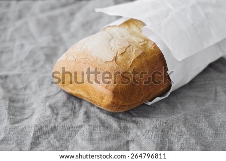 Fresh Delicious Bread In A White Paper Bag