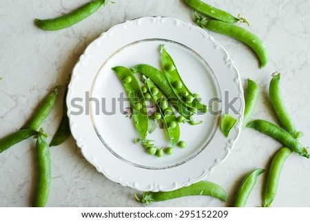 Young Fresh Peas on a White Plate Vegan Food