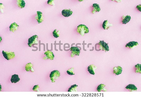 Fresh Raw Broccoli on Pink Paper Top View