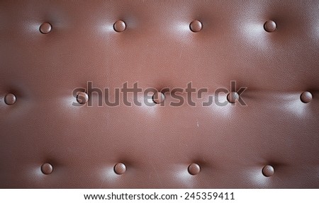 Brown genuine leather sofa background, with vignetting.
