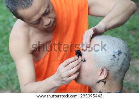 Phuket Thailand ,June 26 : Shaved ordained Buddhist ceremony in Thailand. Thai man gets his head shaved   JUNE 26 , 2015 : in Wat  Kathu Phuket  Thailand